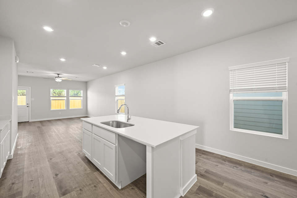 A kitchen with white cabinets.