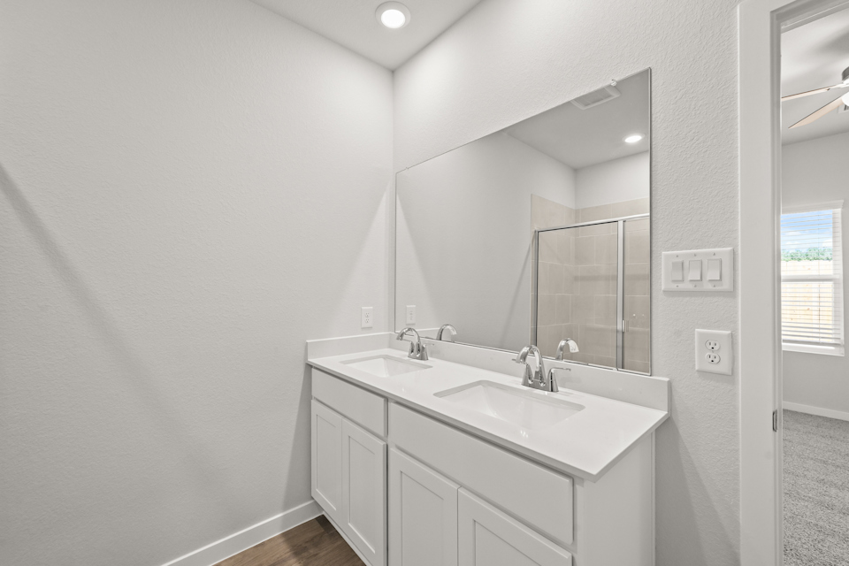 A bathroom with a large mirror.