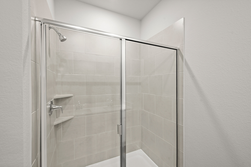 A shower with a glass door.