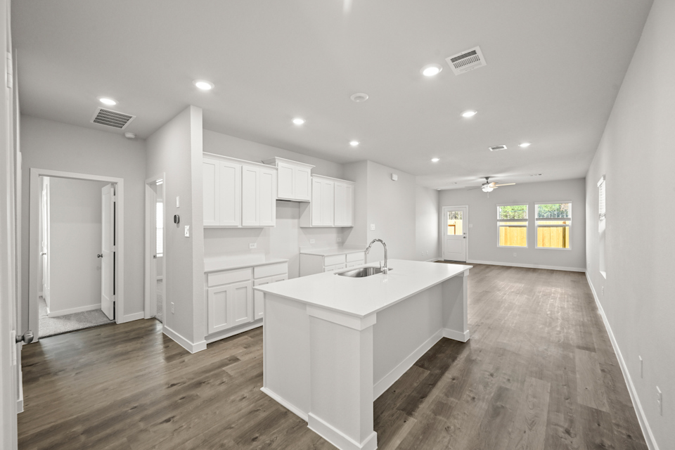 A kitchen with white cabinets.