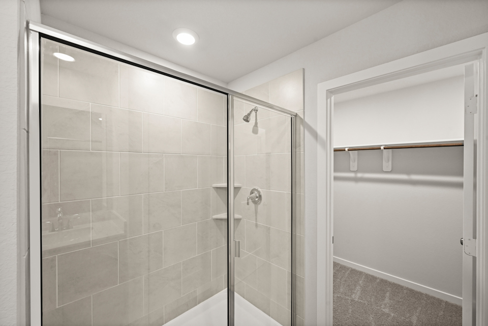 A shower with a glass door.