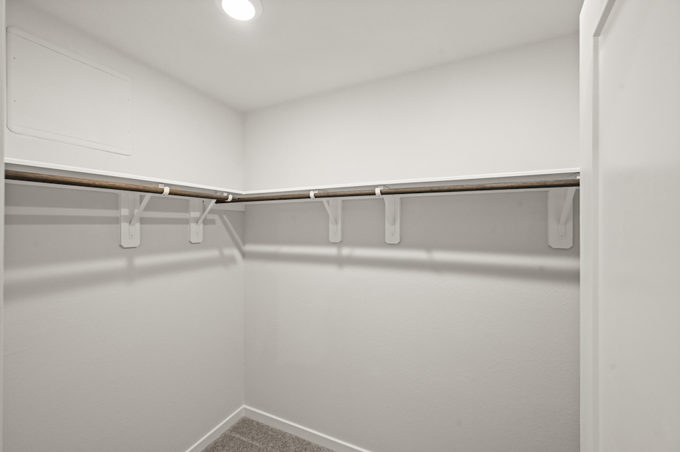 A white wall with a metal bar.