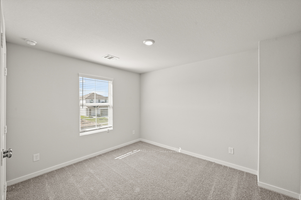 A room with a window and a door.