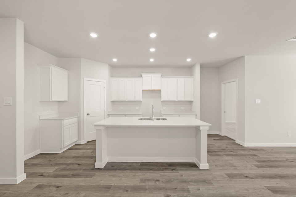 A kitchen with white cabinets.