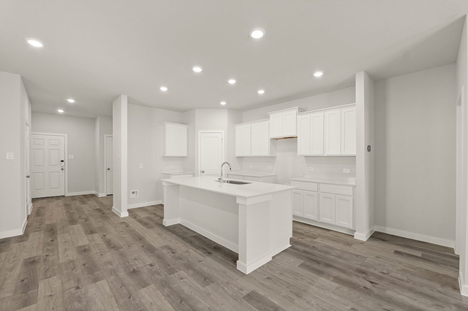 A large kitchen with white cabinets.