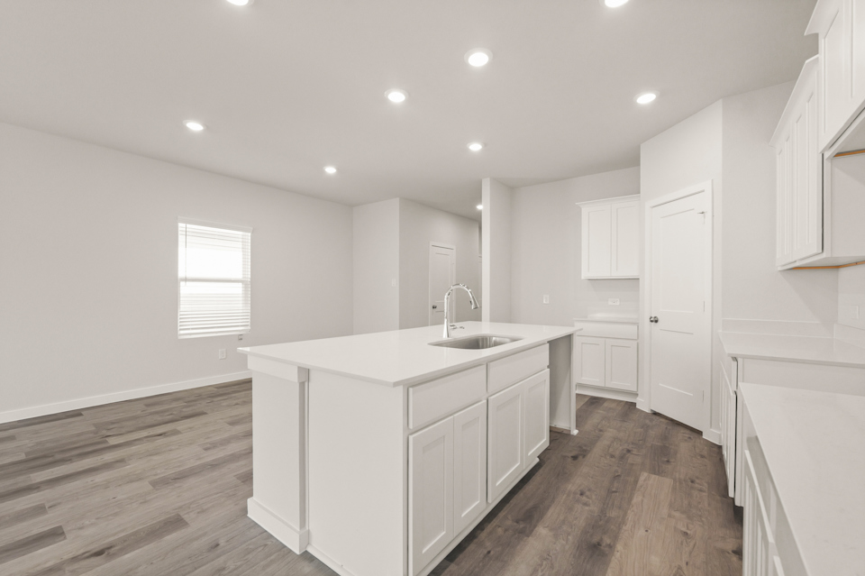 A kitchen with white cabinets.