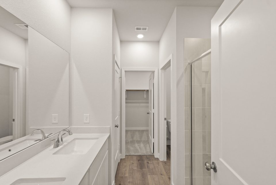 A bathroom with a sink and a shower.