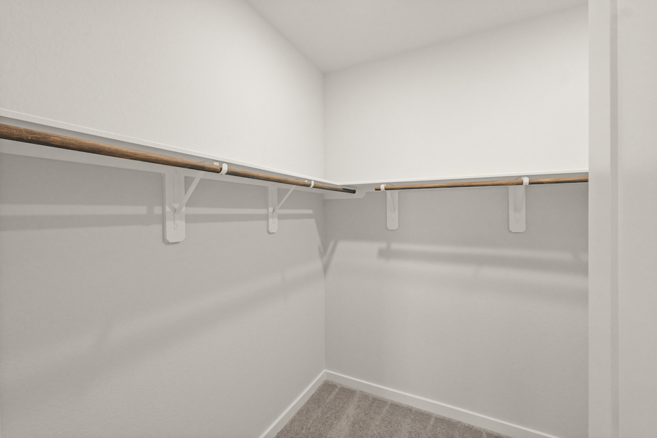 A white wall with a metal bar.