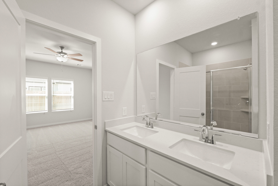 A bathroom with a large mirror.