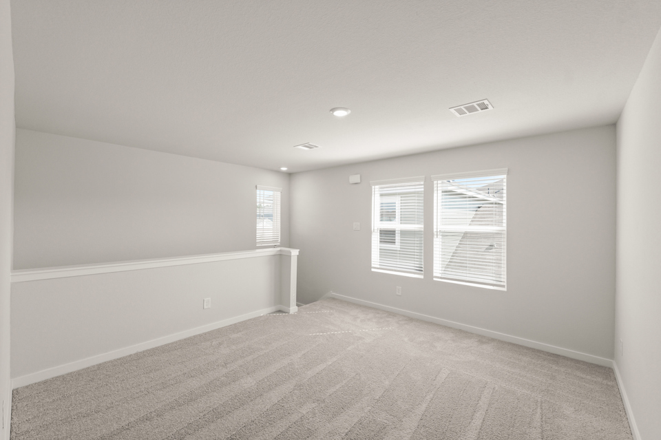 A room with a white wall and a window.