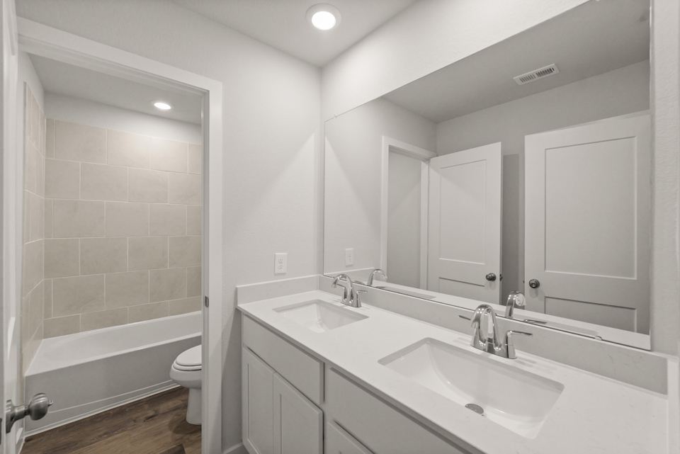 A bathroom with a tub sink and toilet.