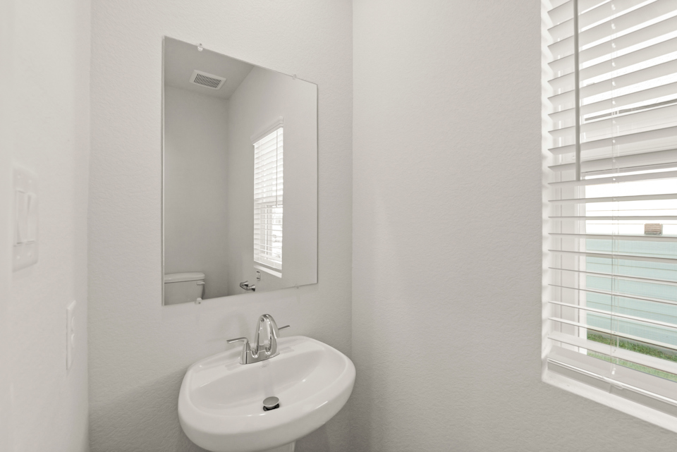 A bathroom with a mirror and sink.