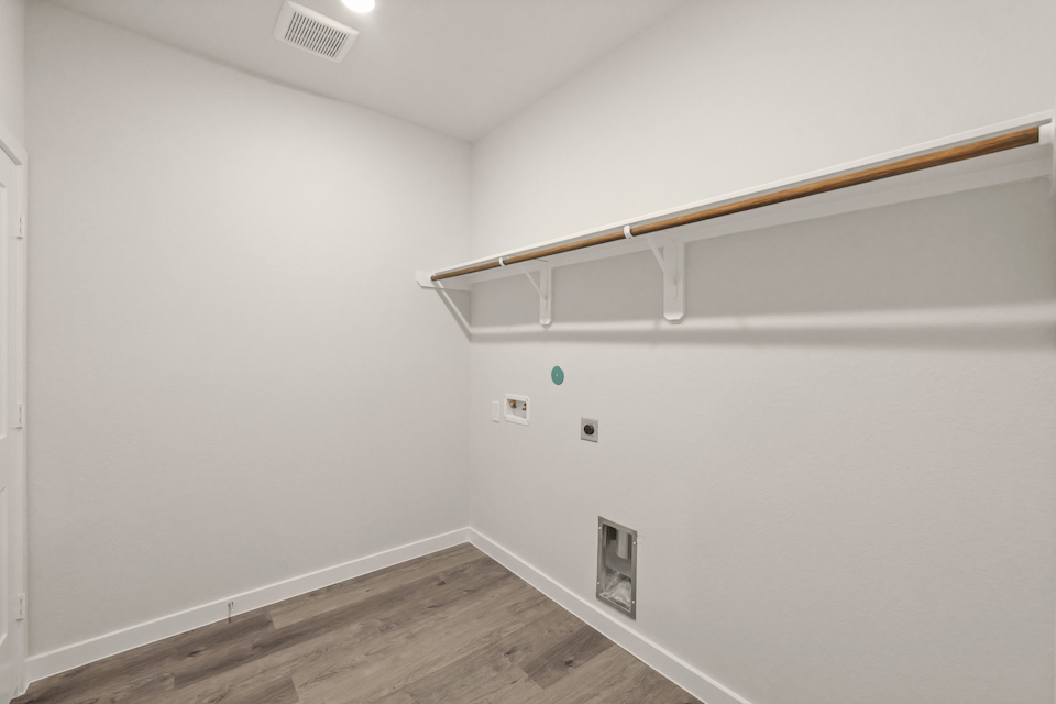 A white wall with a light fixture.