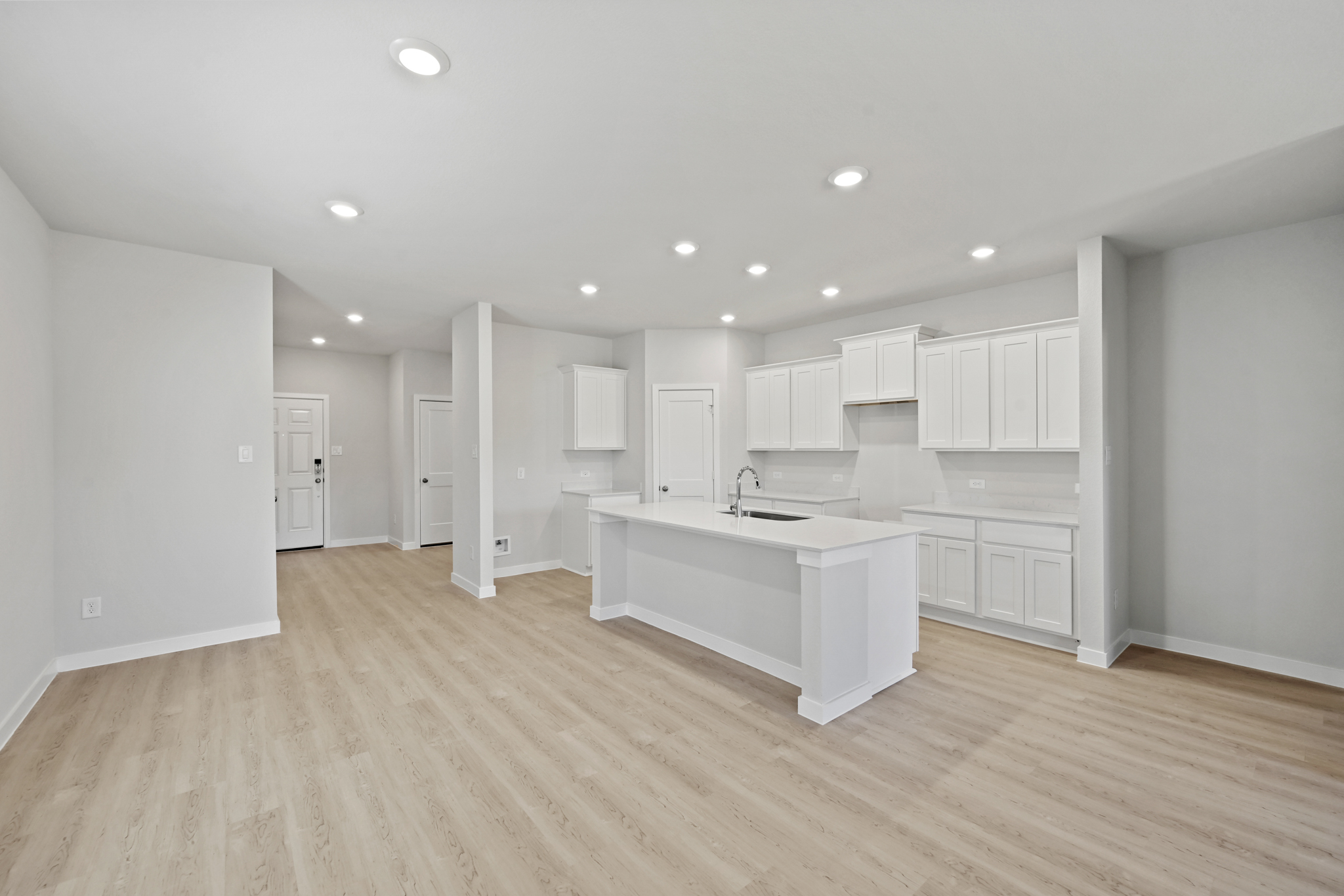 A large white kitchen with white cabinets.