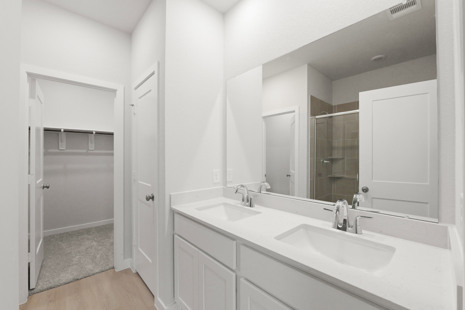 A bathroom with a large mirror.