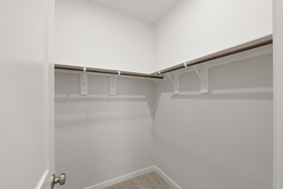 A white door with a metal bar.