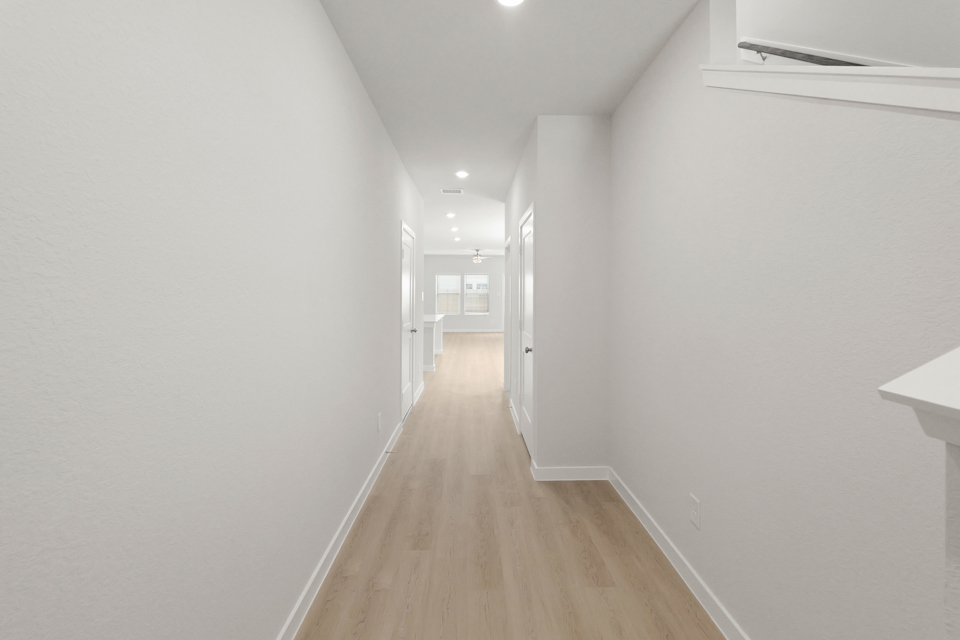 A long hallway with white walls.