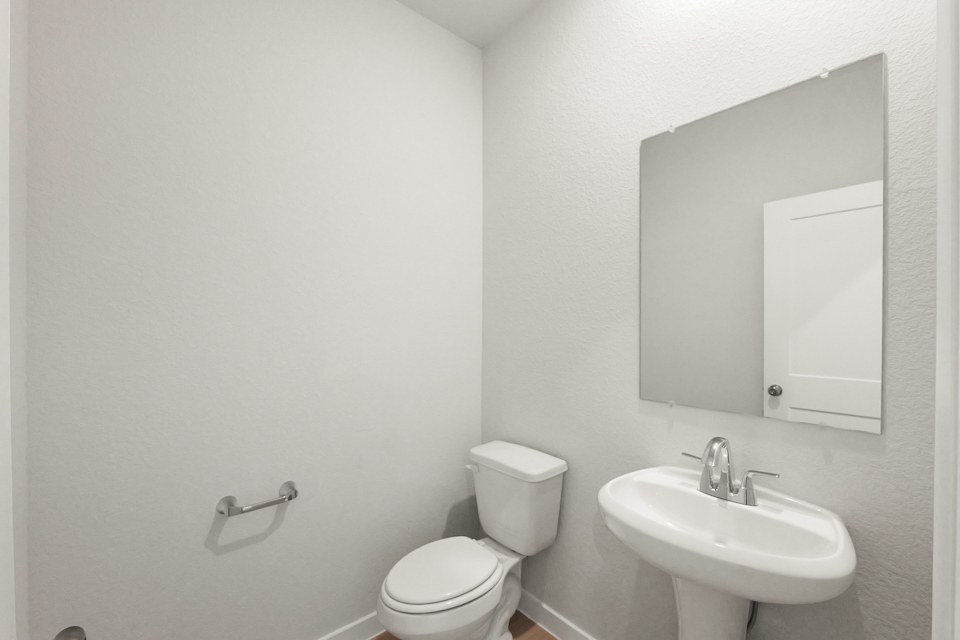 A bathroom with a toilet and sink.