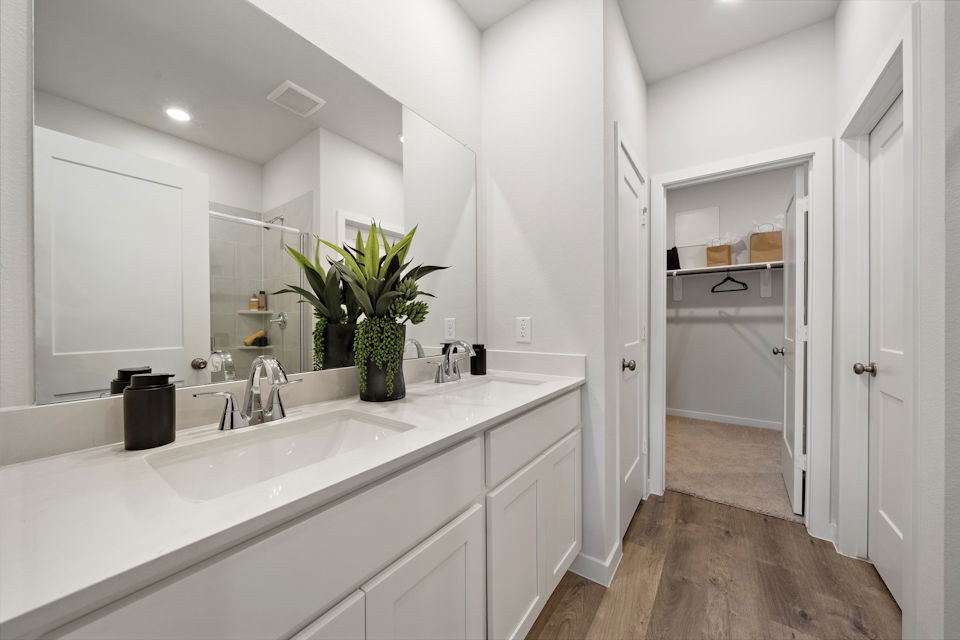 A bathroom with white cabinets.