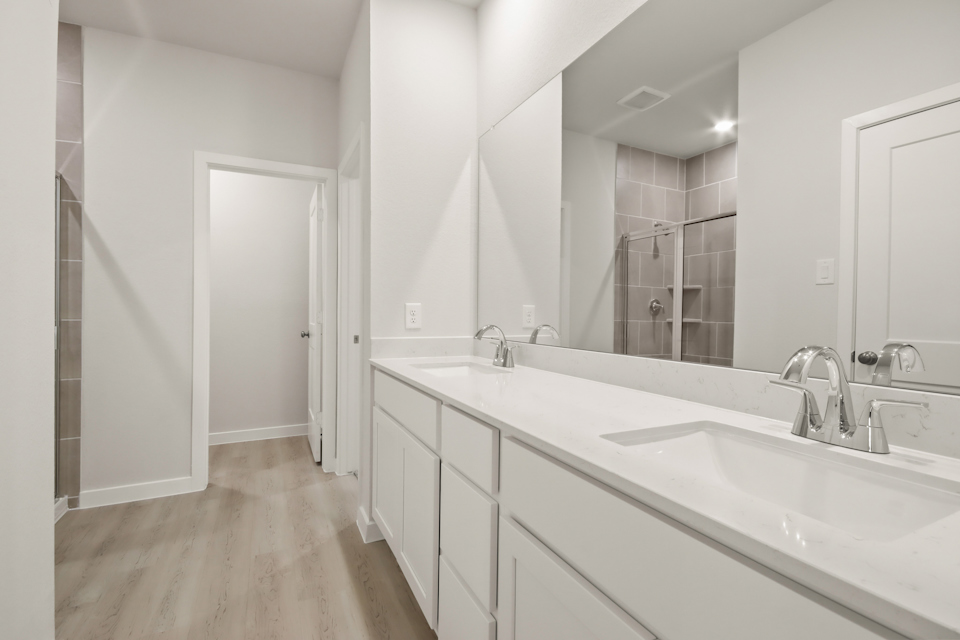 A bathroom with a large mirror.