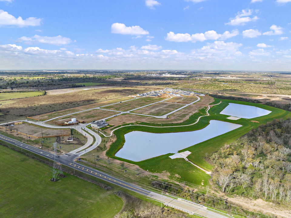 A river running through a valley with Prairie Queen Recreation Area in the background.