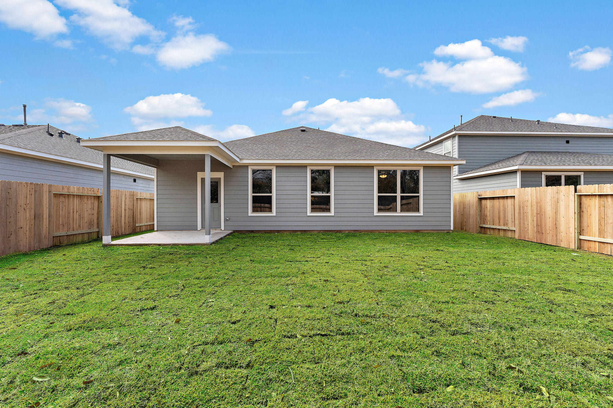 A house with a fence and grass.