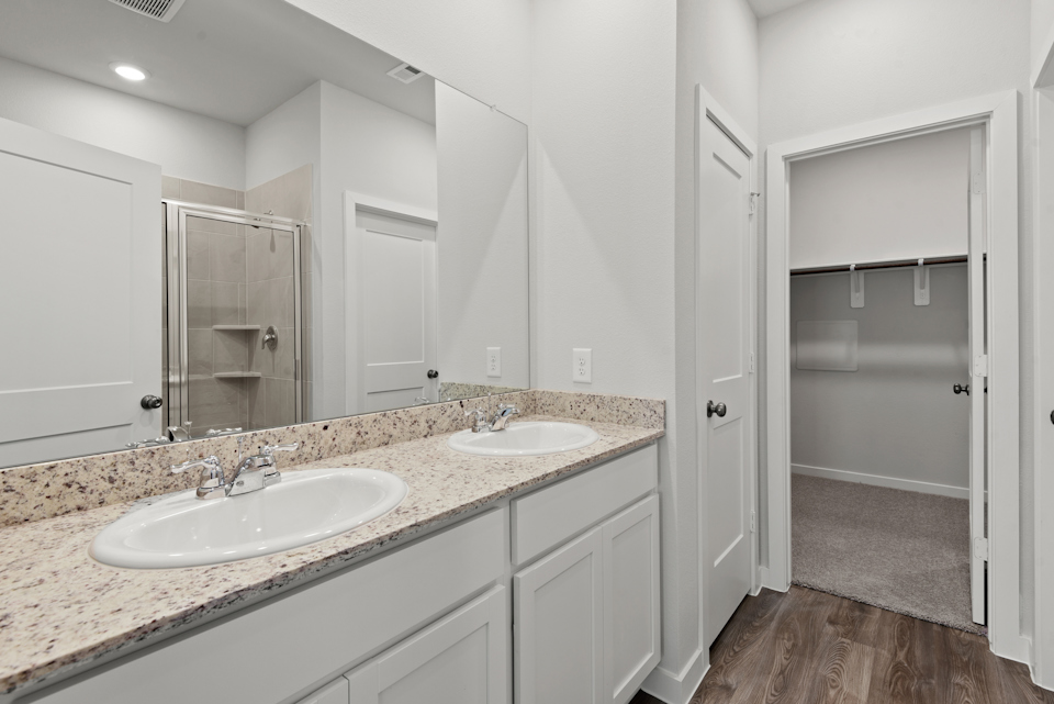 A bathroom with a large mirror.