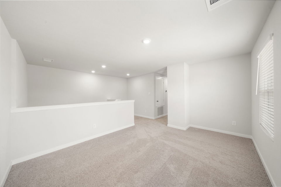 A long hallway with white walls.