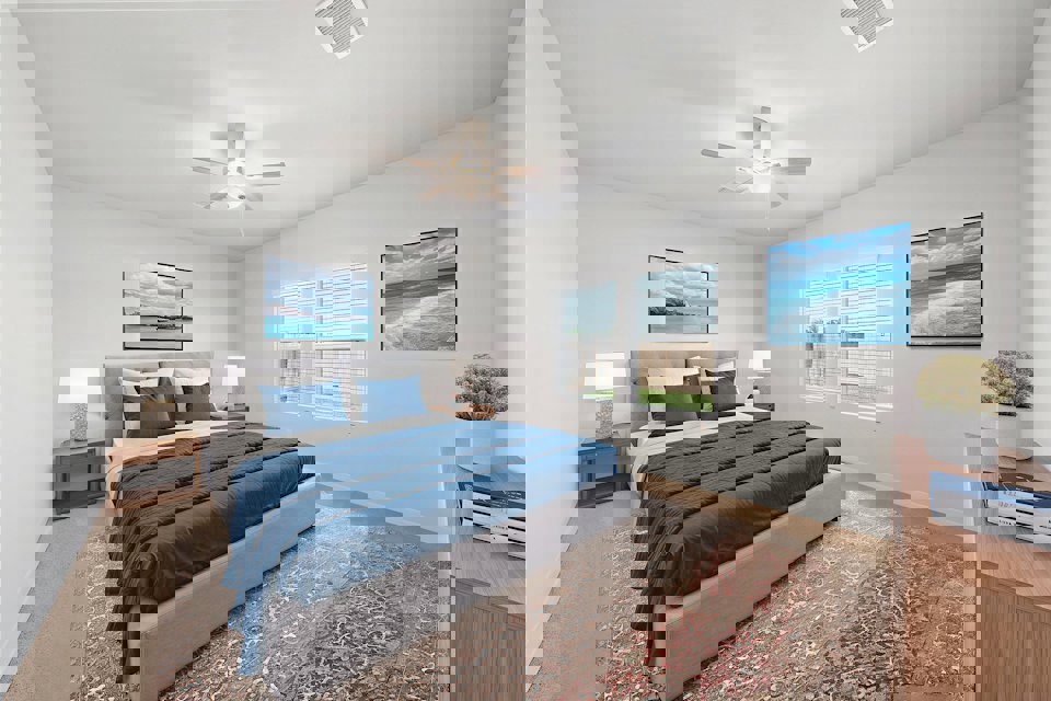 A bedroom with a bed and a fan.