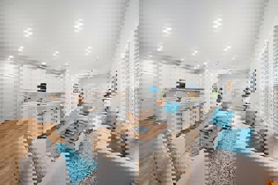 A living room with a large white couch and a table.