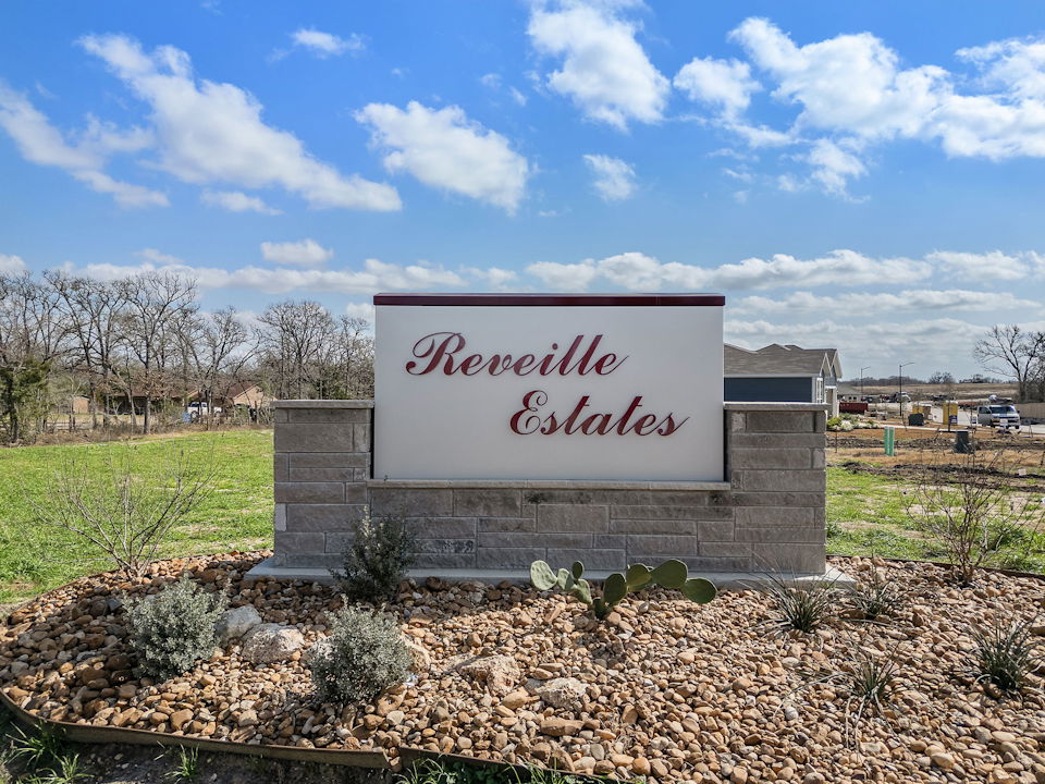 A sign on a stone wall.