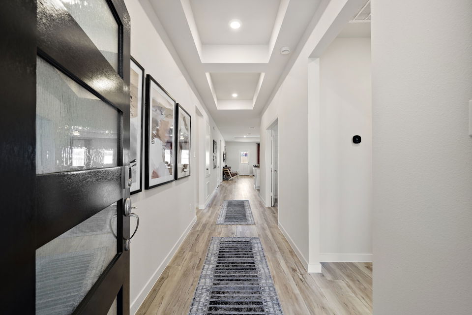 A hallway with white walls.
