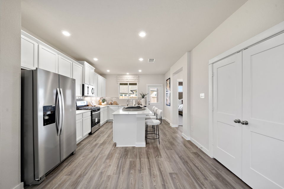 A kitchen with white cabinets.