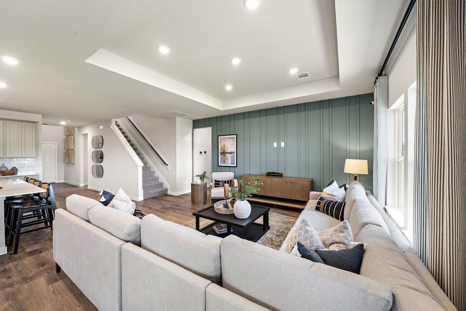A large living room with a staircase.