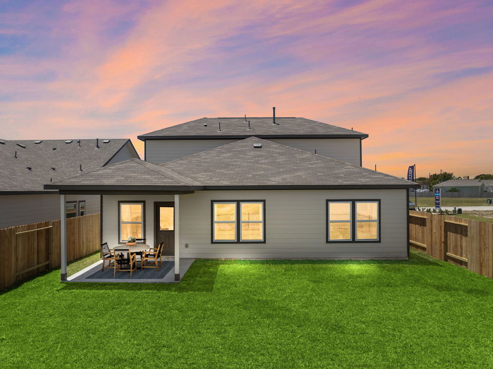 A house with a patio and a table in the front.