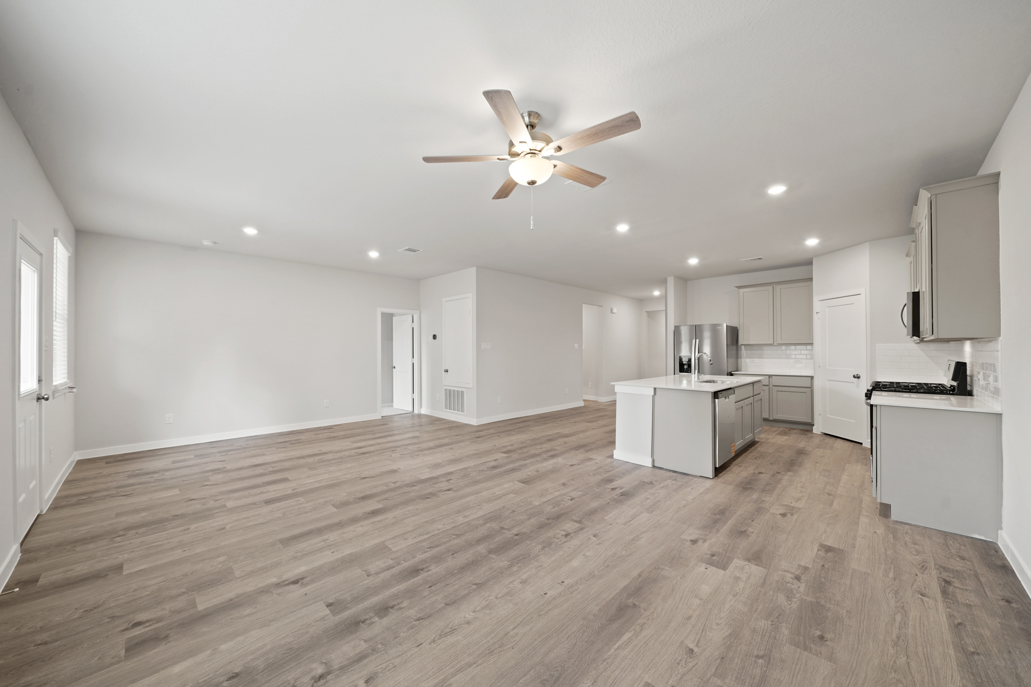 A large kitchen with white cabinets.