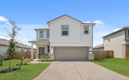 A white house with a driveway.