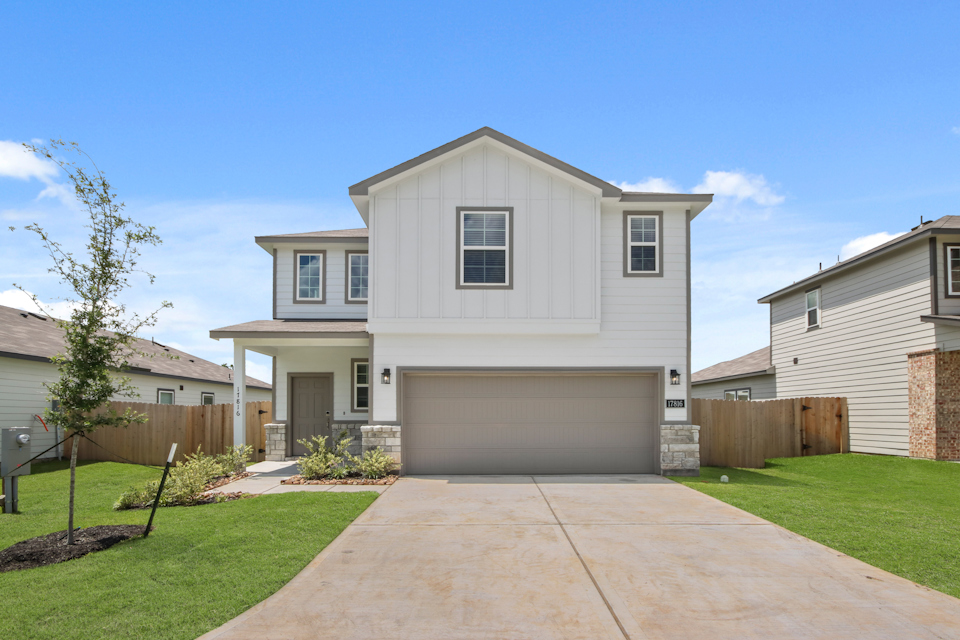 A white house with a driveway.