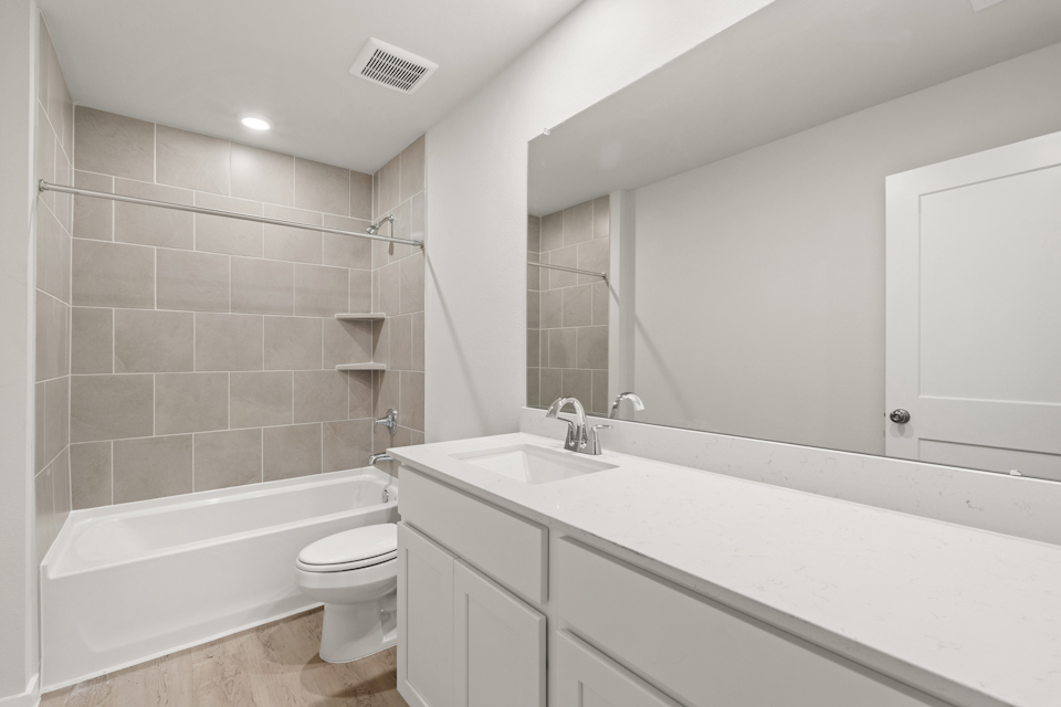 A bathroom with a tub sink and toilet.
