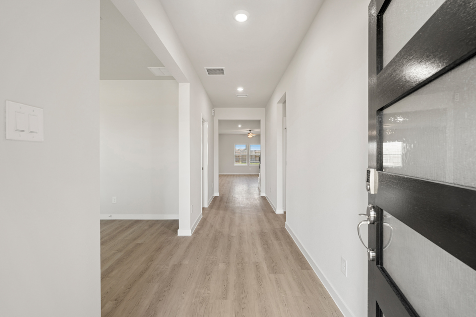 A hallway with white walls.