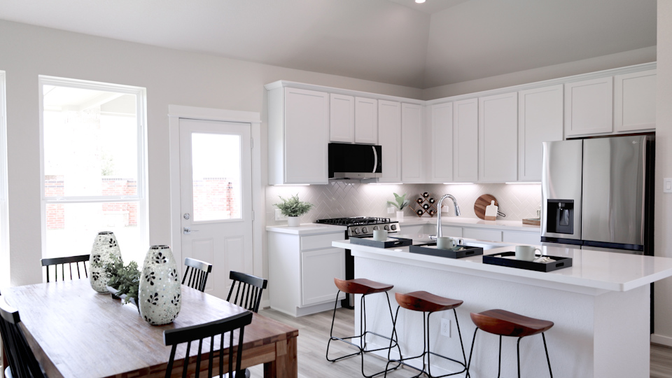 A kitchen with white cabinets.