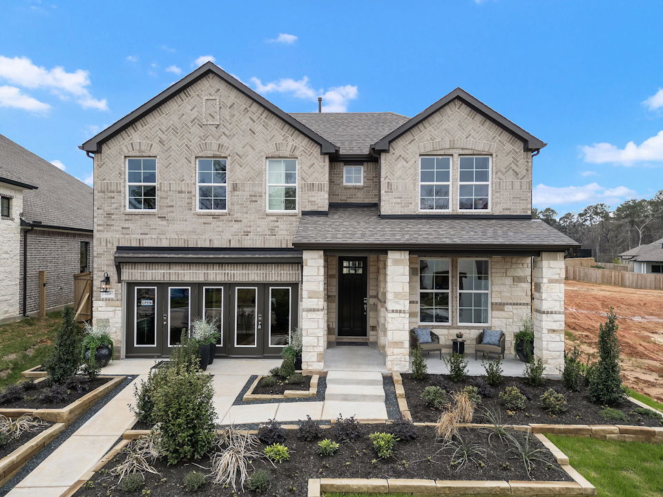 A stone house with a stone driveway.