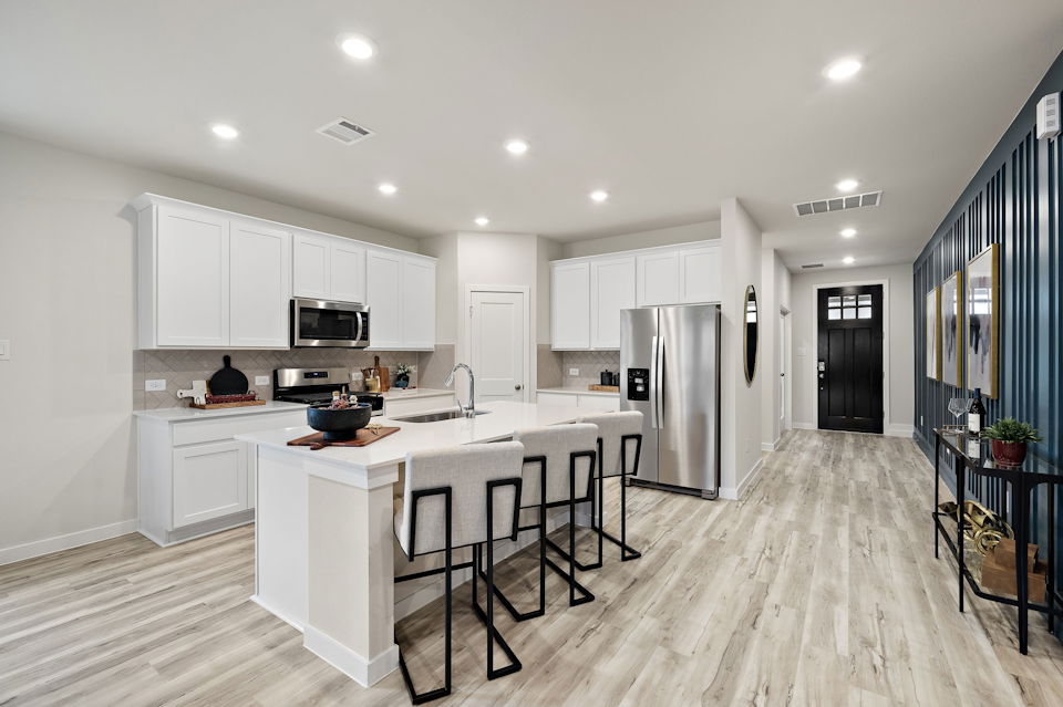 A kitchen with white cabinets.