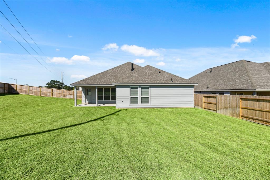 A house with a fence and grass.
