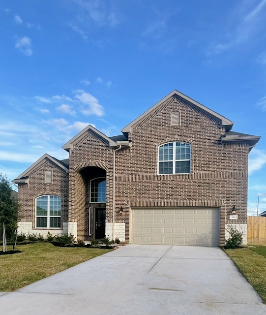 A brick house with a garage.