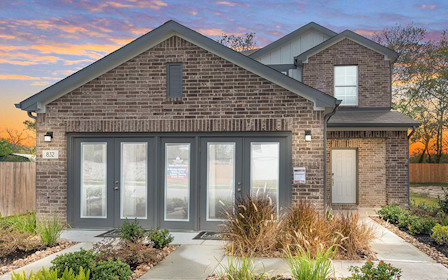 A brick building with a driveway.