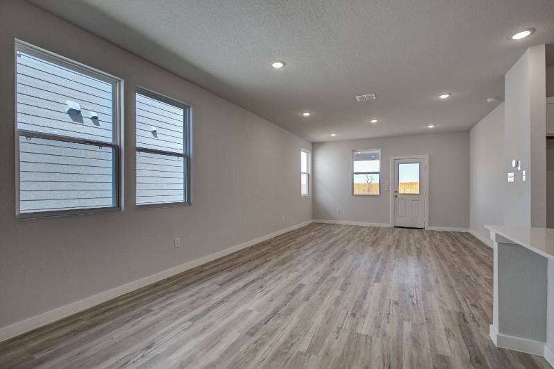 A room with a wood floor and white walls.