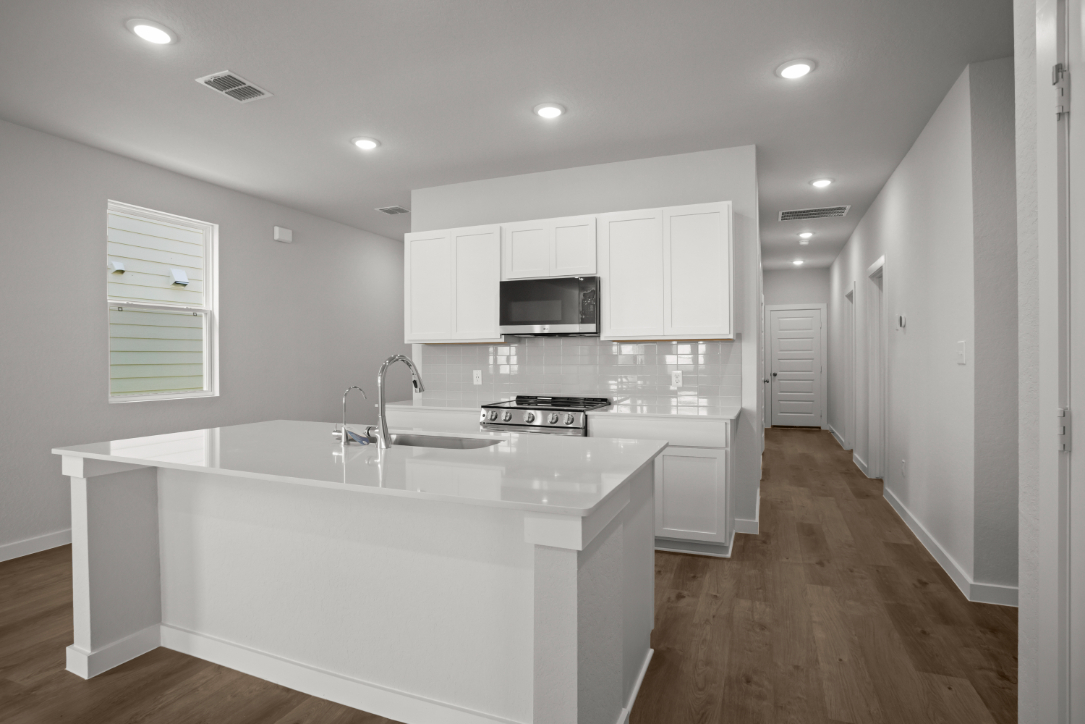 A kitchen with white cabinets.