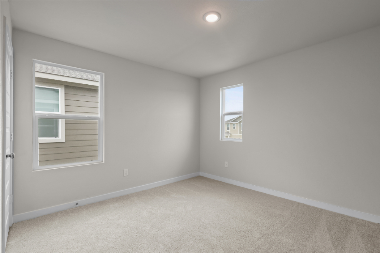 A room with a window and a carpet.