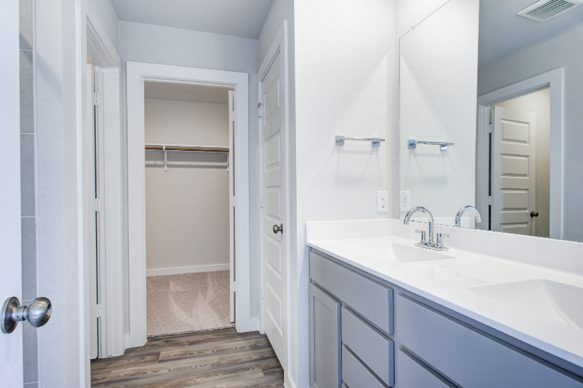 A bathroom with a sink and a shower.